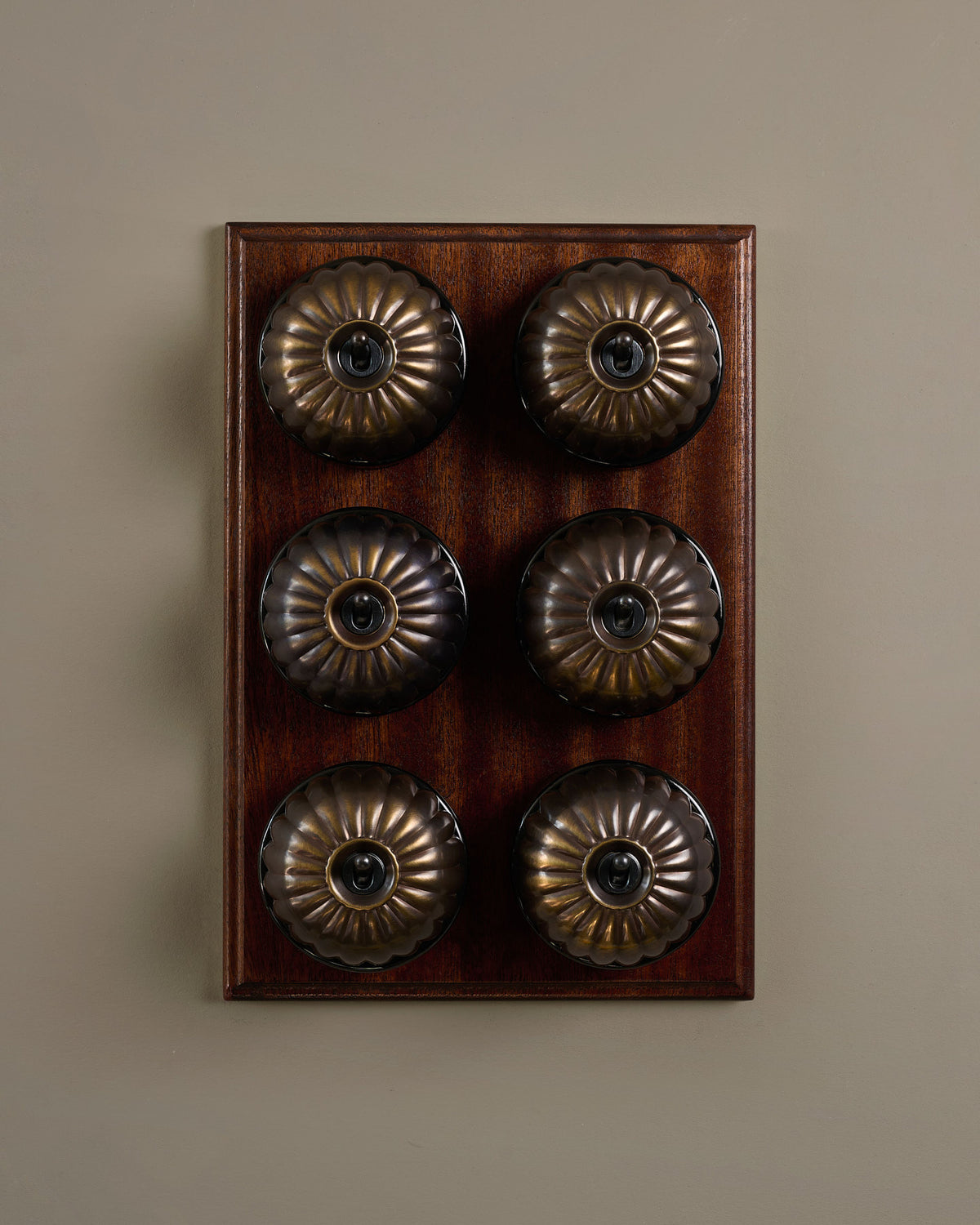 The Jelly Toggle Switch (6 Gang & Mahogany Finish Pattress) - Oxidised Brass with Black Base. TEST