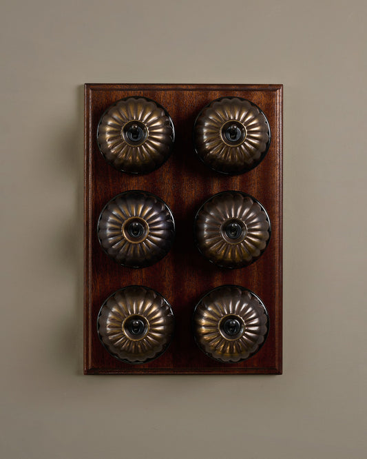 The Jelly Toggle Switch (6 Gang & Mahogany Finish Pattress) - Oxidised Brass with Black Base.