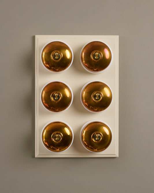 The Dolly Toggle Switch (6 Gang & Primed Maple Pattress) - Heirloom Brass with White Base.