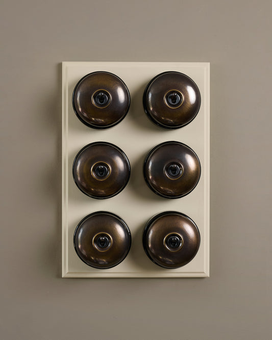The Dolly Toggle Switch (6 Gang & Primed Maple Pattress) - Oxidised Brass with Black Base.