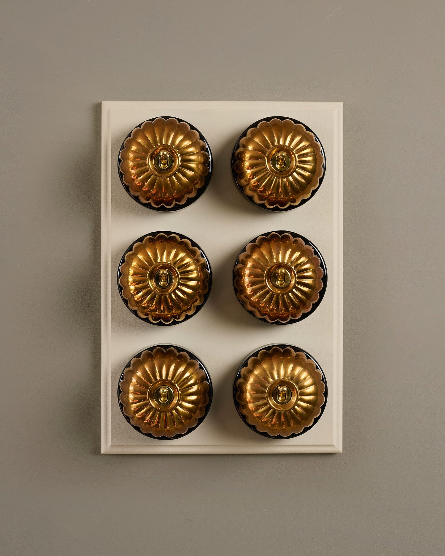 The Jelly Toggle Switch (6 Gang & Primed Maple Pattress) - Heirloom Brass with Black Base.