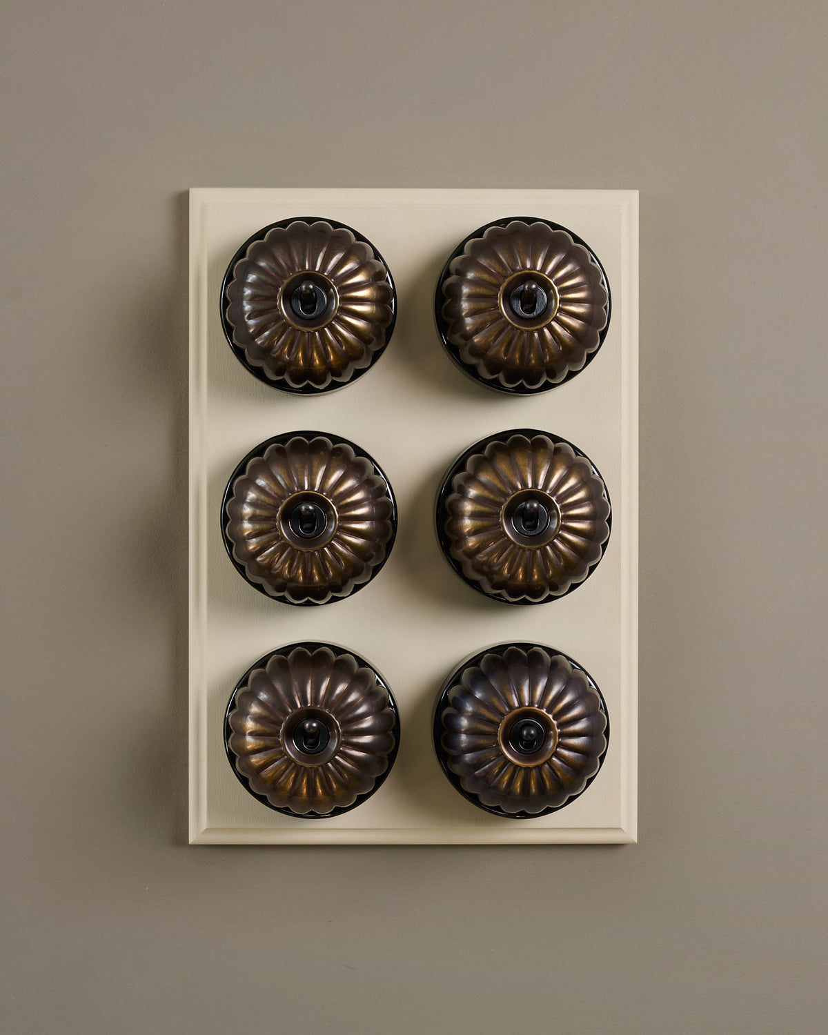 The Jelly Toggle Switch (6 Gang & Primed Maple Pattress) - Oxidised Brass with Black Base. TEST