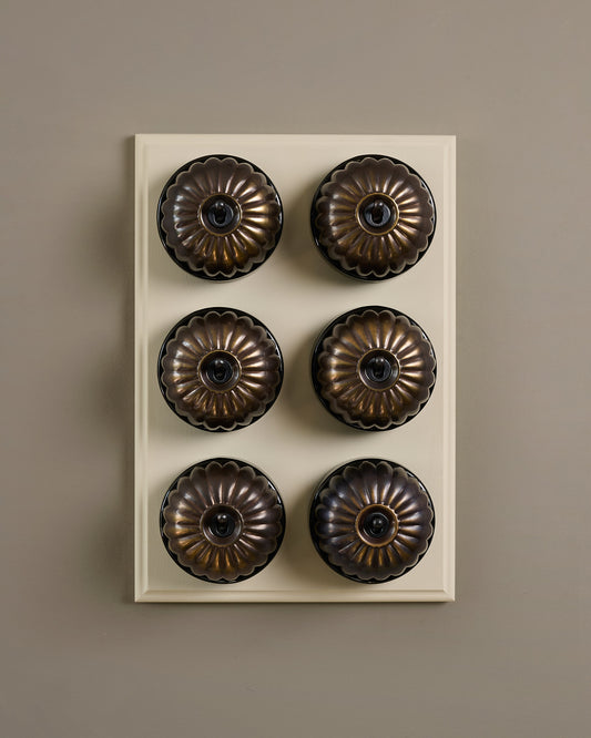 The Jelly Toggle Switch (6 Gang & Primed Maple Pattress) - Oxidised Brass with Black Base.