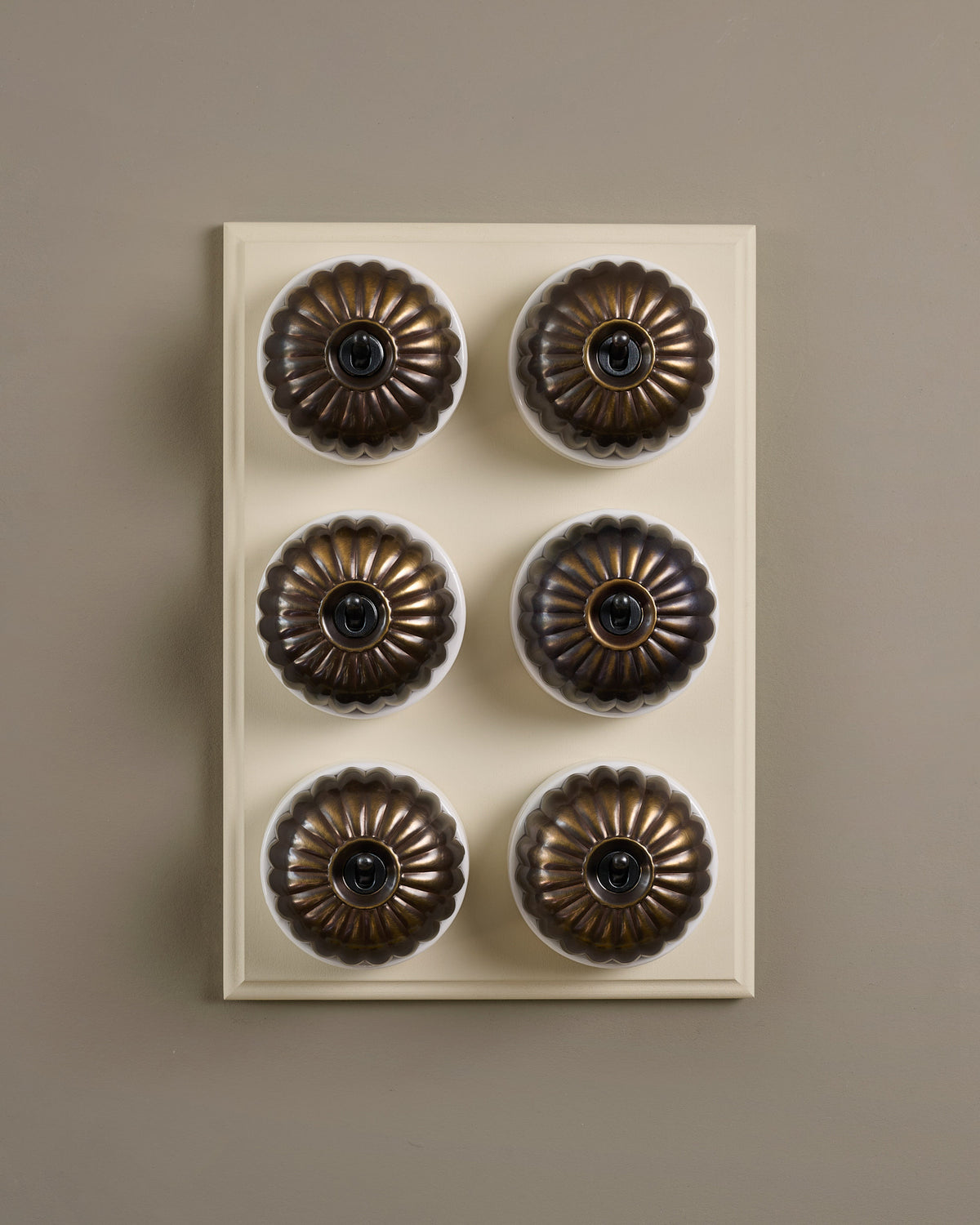 The Jelly Toggle Switch (6 Gang & Primed Maple Pattress) - Oxidised Brass with White Base. TEST