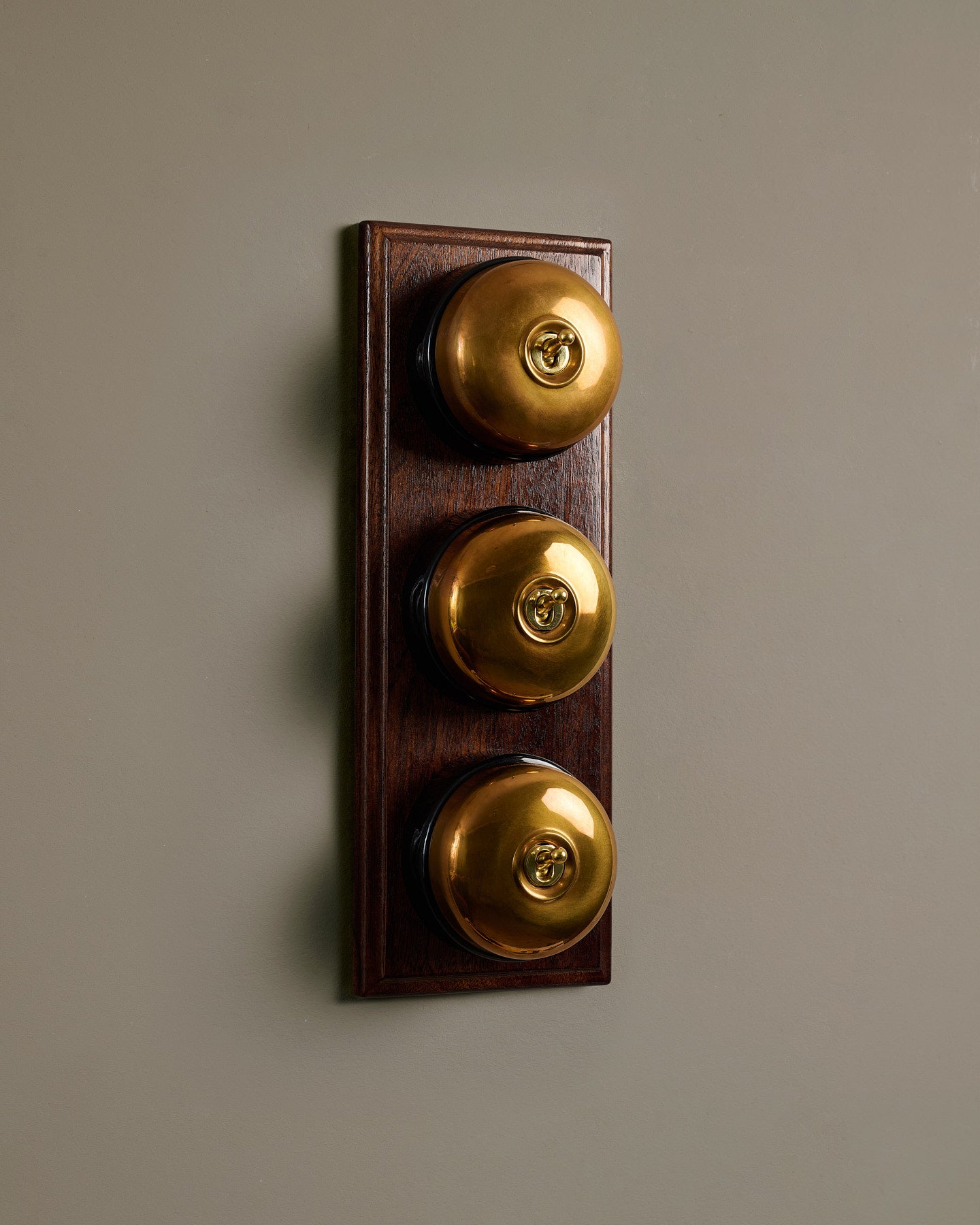 The Dolly Toggle Switch (3 Gang & Mahogany Finish Pattress) - Heirloom Brass with Black Base.