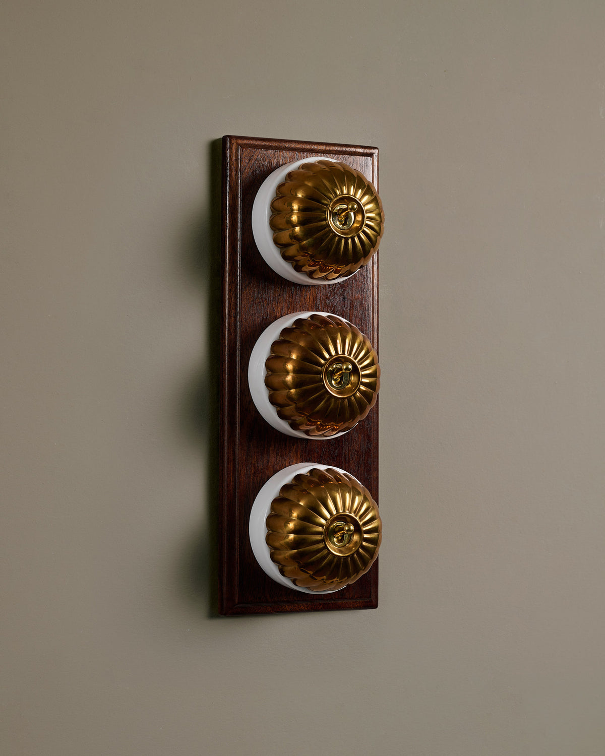 The Jelly Toggle Switch (3 Gang & Mahogany Finish Pattress) - Heirloom Brass with White Base. TEST