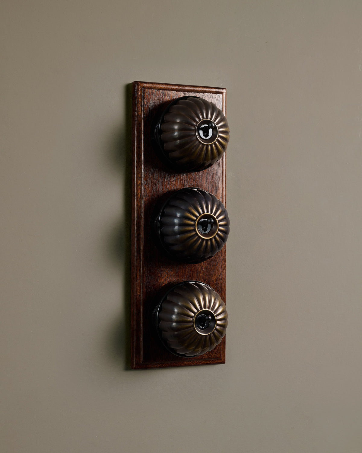 The Jelly Toggle Switch (3 Gang & Mahogany Finish Pattress) - Oxidised Brass with Black Base. TEST
