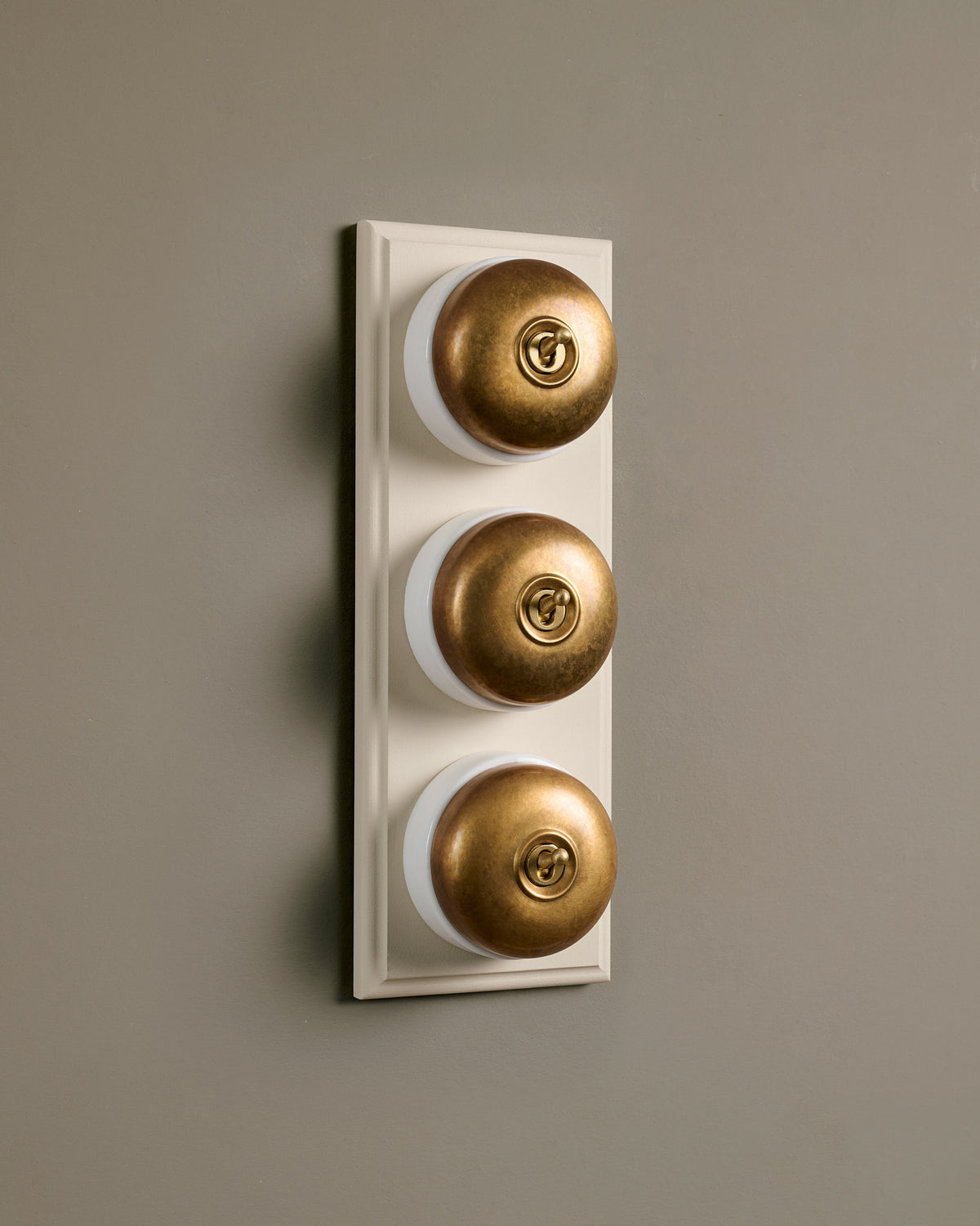 The Dolly Toggle Switch (3 Gang & Primed Maple Pattress) - Aged Brass with White Base. TEST
