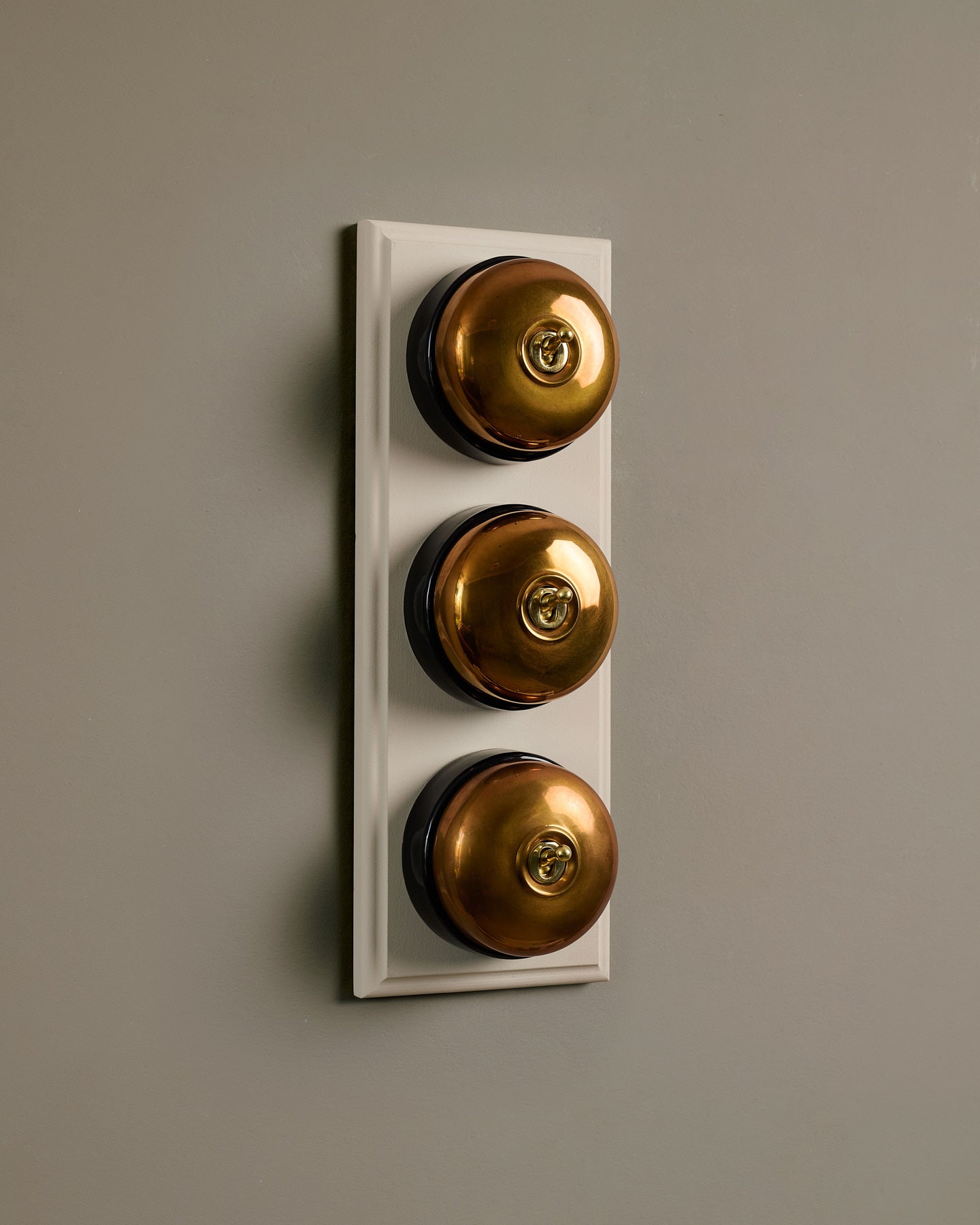 The Dolly Toggle Switch (3 Gang & Primed Maple Pattress) - Heirloom Brass with Black Base.