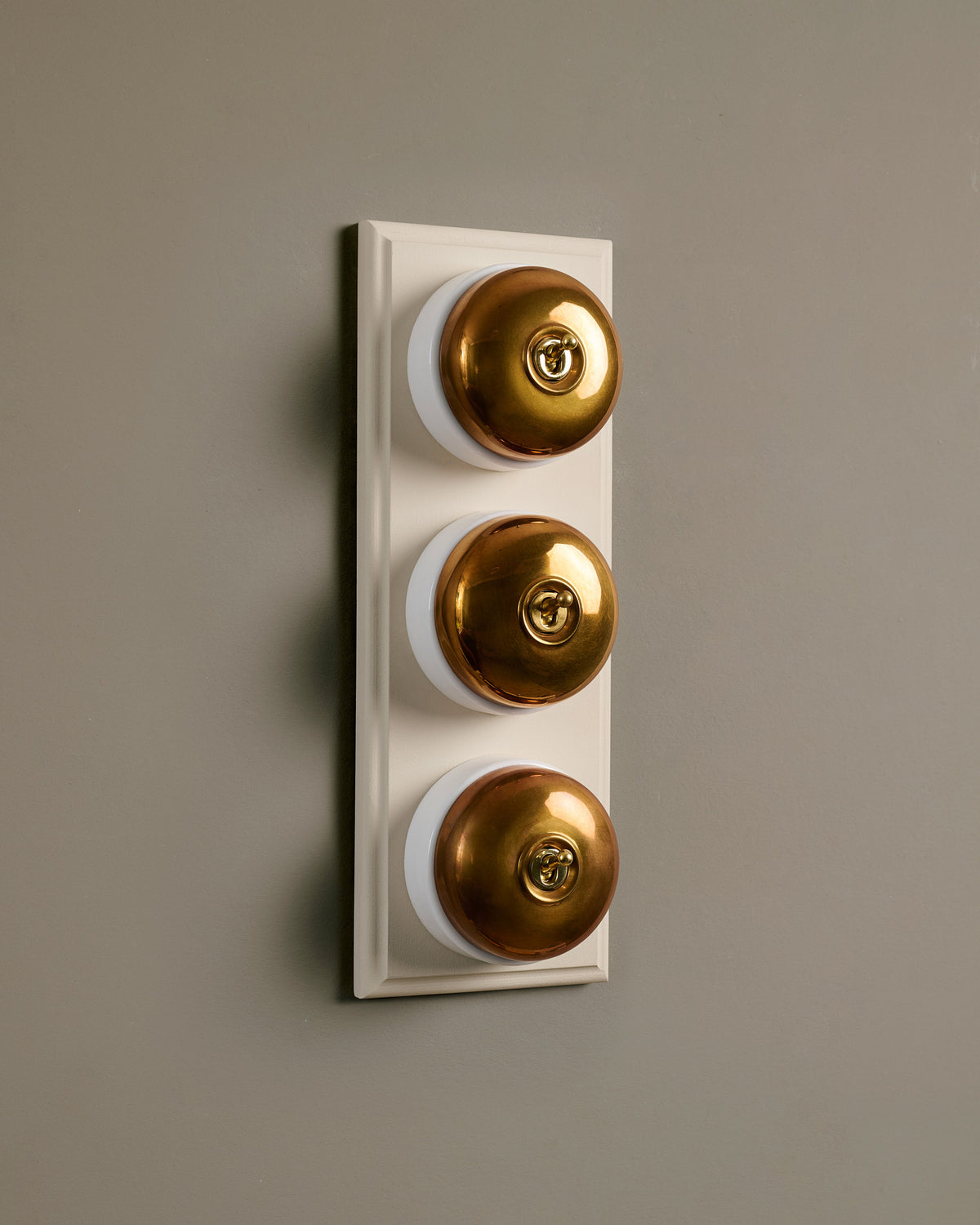 The Dolly Toggle Switch (3 Gang & Primed Maple Pattress) - Heirloom Brass with White Base. TEST