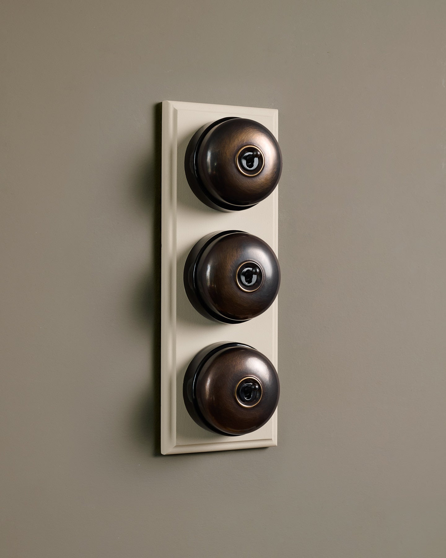 The Dolly Toggle Switch (3 Gang & Primed Maple Pattress) - Oxidised Brass with Black Base.