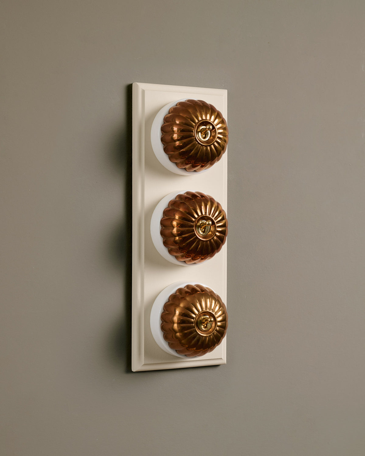 The Jelly Toggle Switch (3 Gang & Primed Maple Pattress) - Heirloom Brass with White Base. TEST
