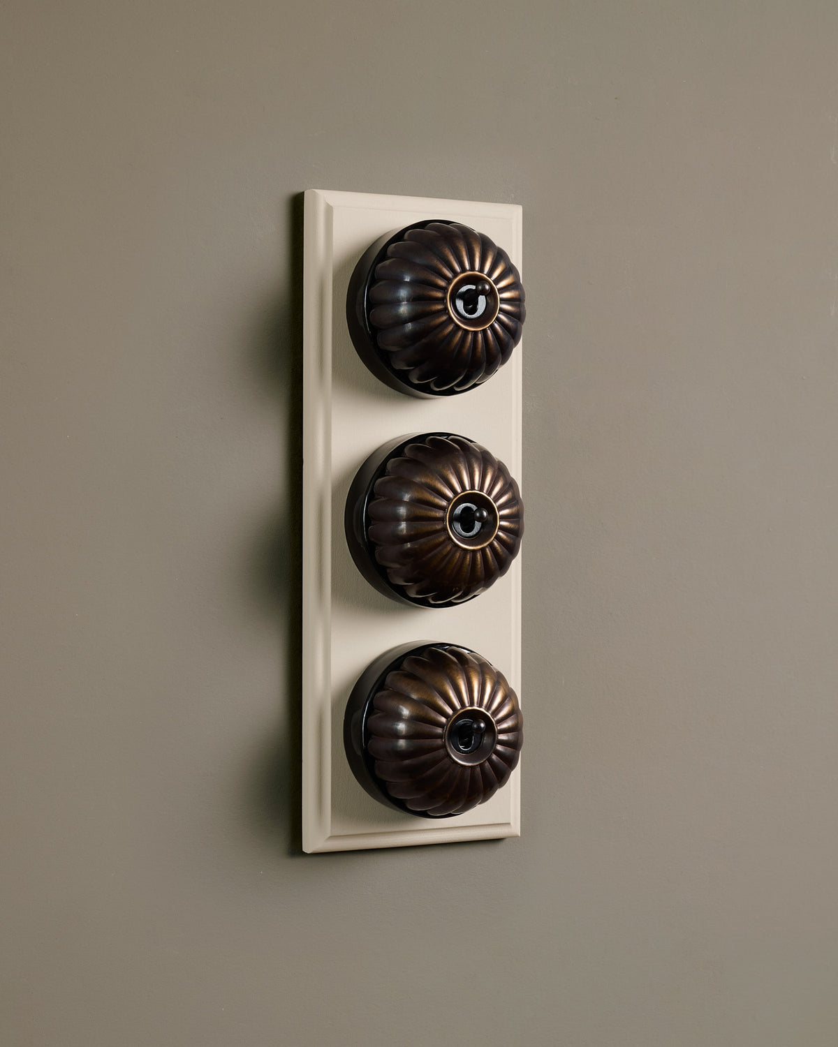 The Jelly Toggle Switch (3 Gang & Primed Maple Pattress) - Oxidised Brass with Black Base. TEST
