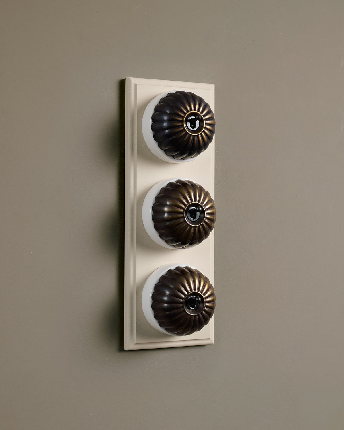 The Jelly Toggle Switch (3 Gang & Primed Maple Pattress) - Oxidised Brass with White Base. TEST