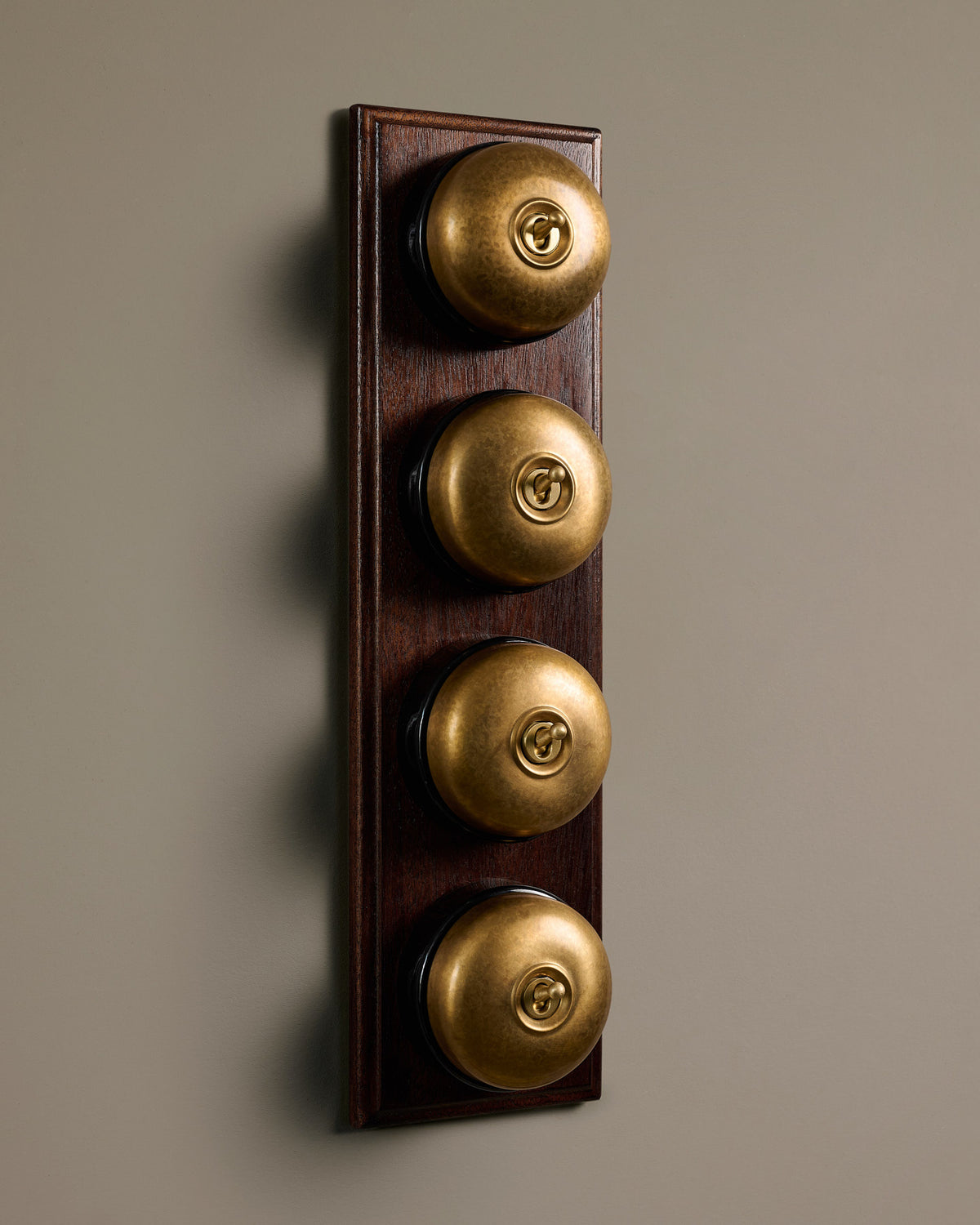 The Dolly Toggle Switch (4 Gang Row & Mahogany Finish Pattress) - Aged Brass with Black Base. TEST