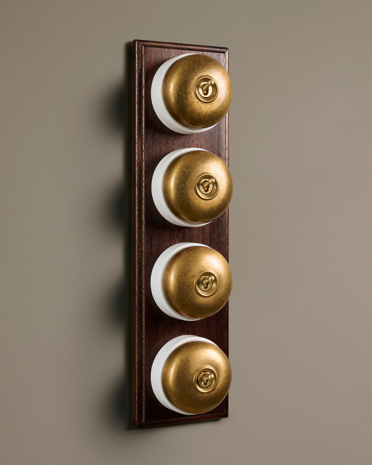 The Dolly Toggle Switch (4 Gang Row & Mahogany Finish Pattress) - Aged Brass with White Base. TEST