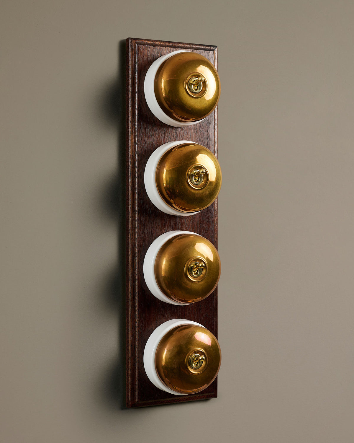 The Dolly Toggle Switch (4 Gang Row & Mahogany Finish Pattress) - Heirloom Brass with White Base. TEST