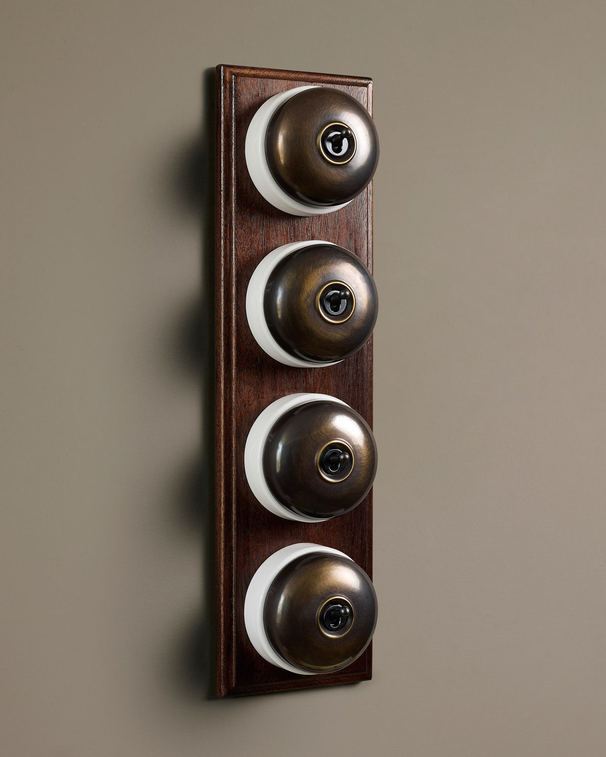 The Dolly Toggle Switch (4 Gang Row & Mahogany Finish Pattress) - Oxidised Brass with White Base. TEST