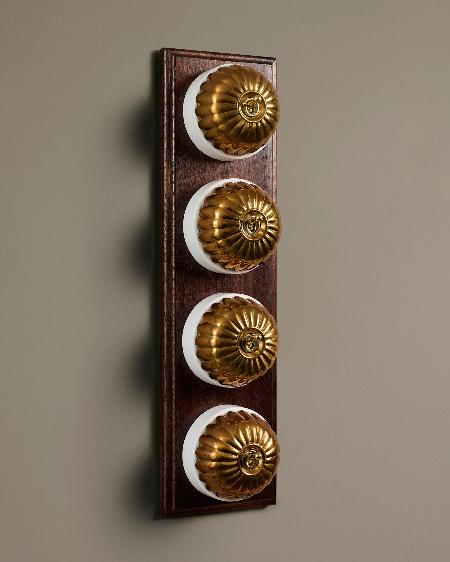 The Jelly Toggle Switch (4 Gang Row & Mahogany Finish Pattress) - Heirloom Brass with White Base.