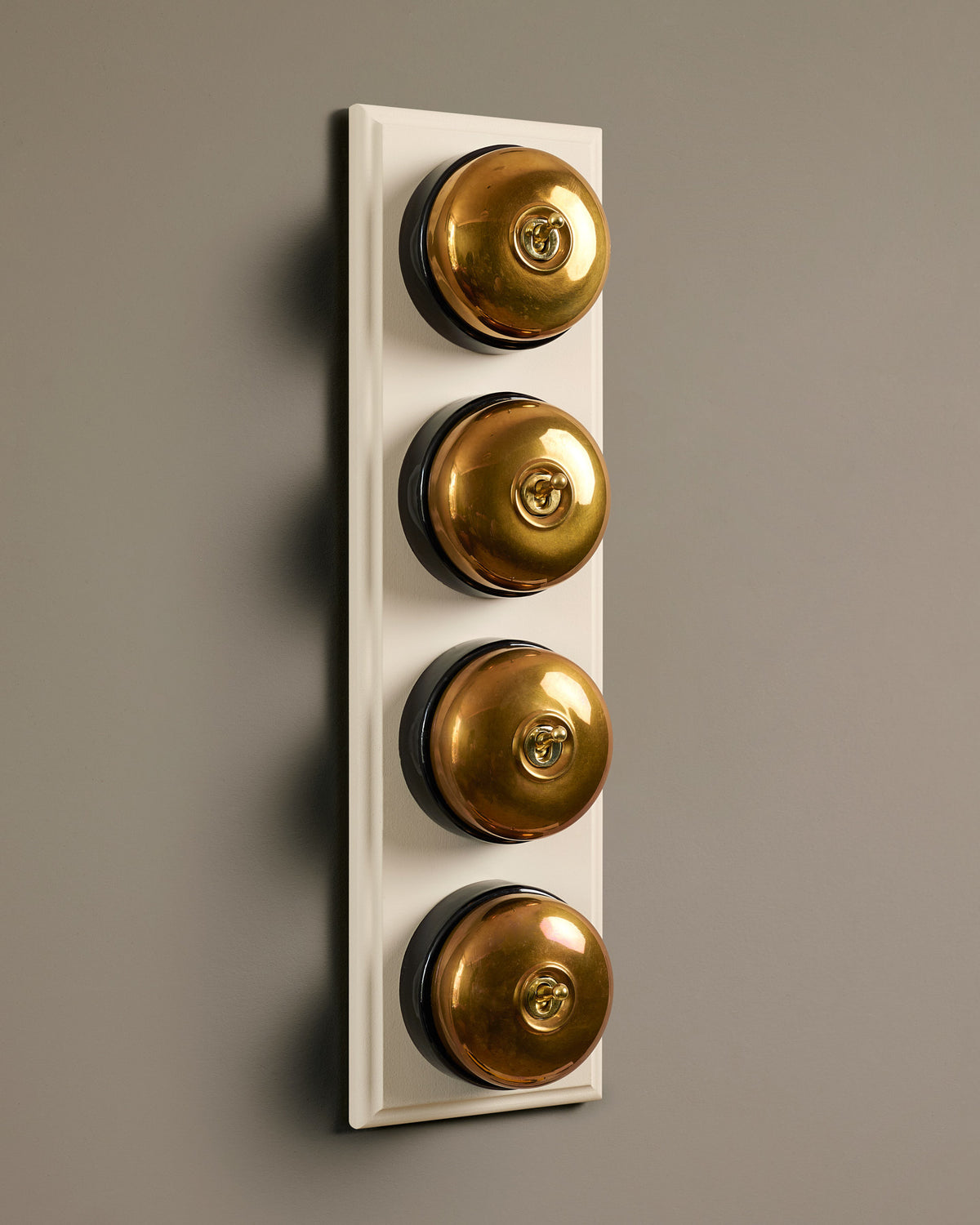 The Dolly Toggle Switch (4 Gang Row & Primed Maple Pattress) - Heirloom Brass with Black Base. TEST
