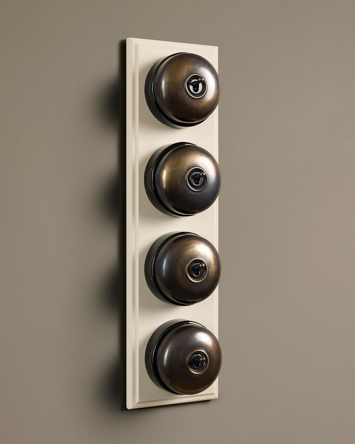The Dolly Toggle Switch (4 Gang Row & Primed Maple Pattress) - Oxidised Brass with Black Base. TEST
