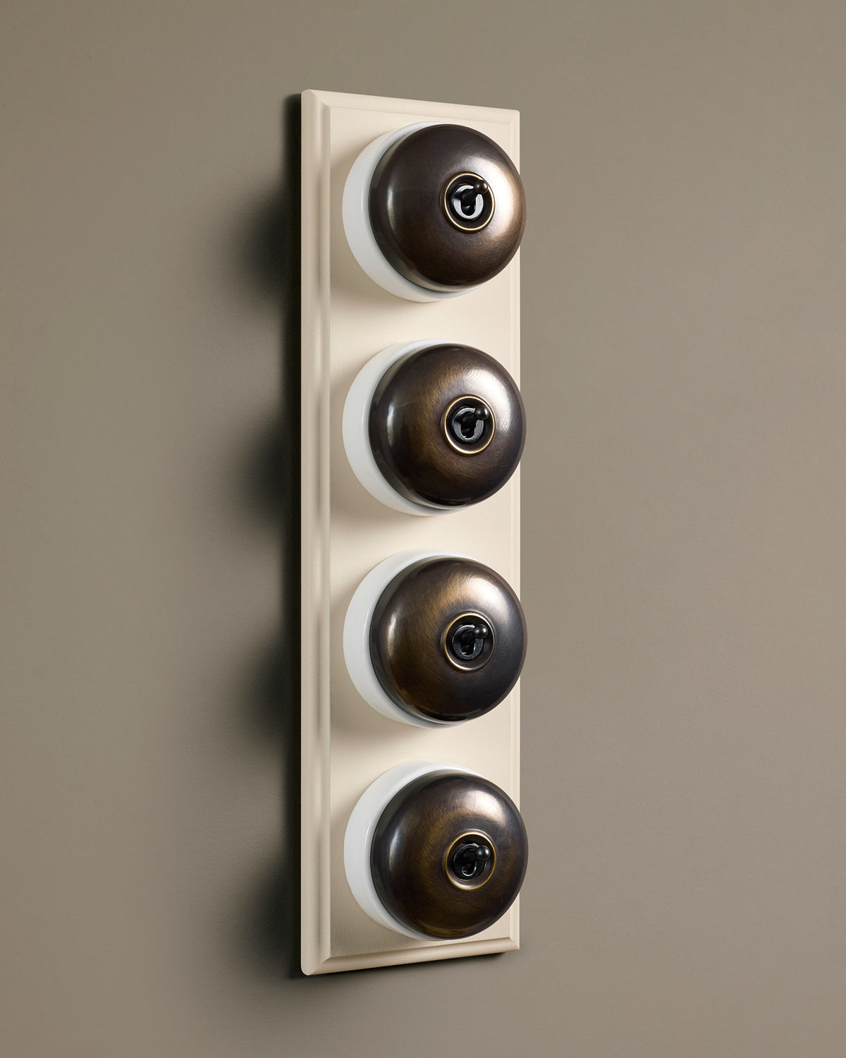 The Dolly Toggle Switch (4 Gang Row & Primed Maple Pattress) - Oxidised Brass with White Base. TEST