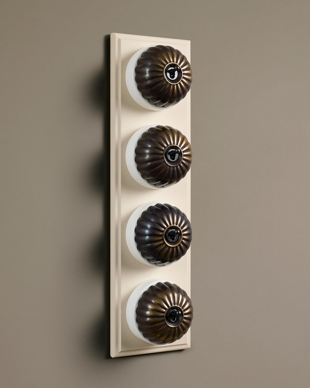 The Jelly Toggle Switch (4 Gang Row & Primed Maple Pattress) - Oxidised Brass with White Base. TEST
