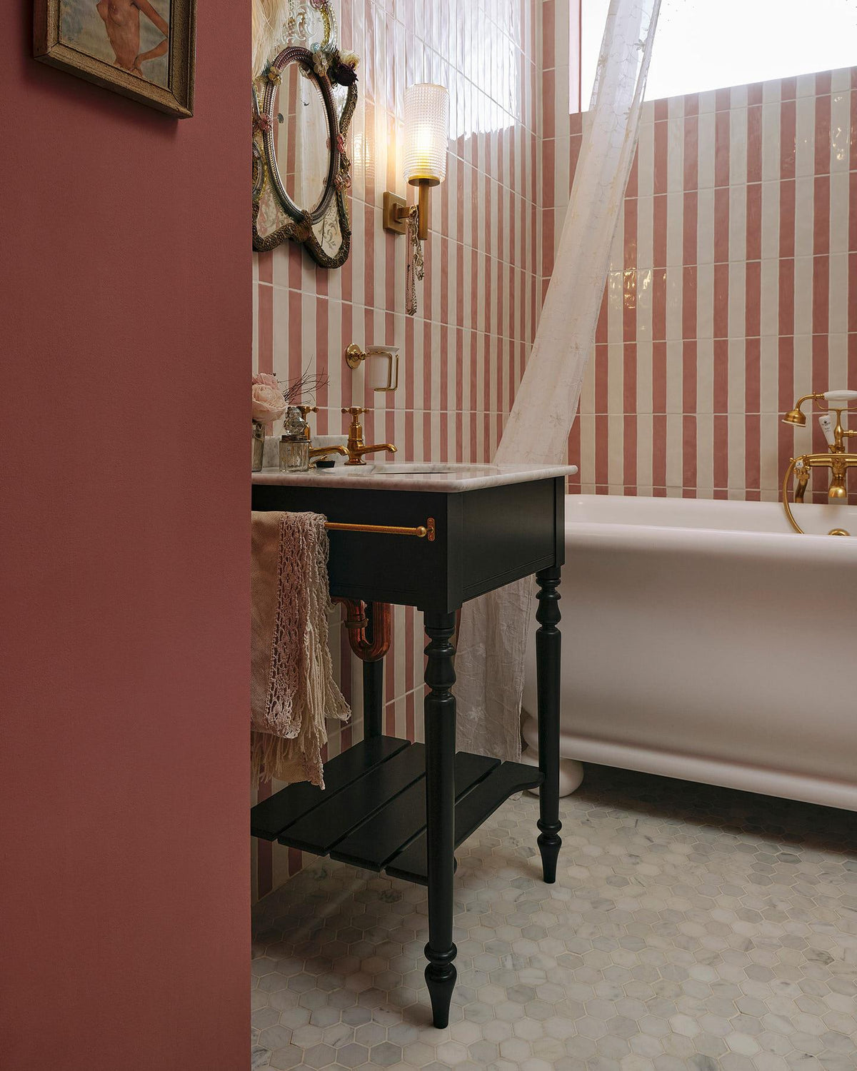 A detailed view of an aged brass towel rail attached to the left side of a Victorian-inspired washstand, a vintage lace hand towel hangs from the rail. | Pillar Taps shown TEST