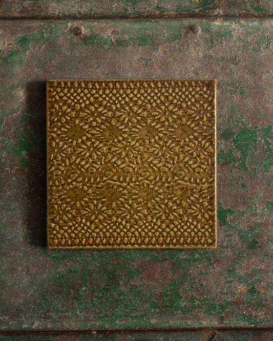 Sepia square with intricate pattern on a textured green surface | Venetian Square