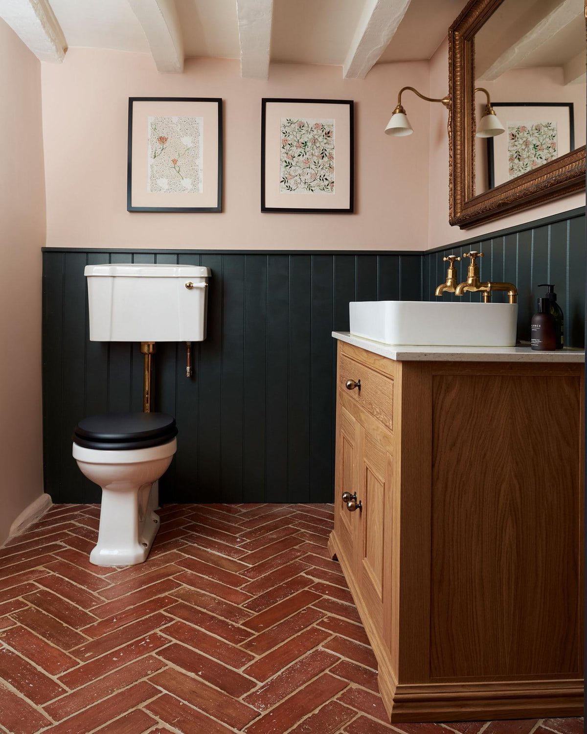 A close-up overhead view of parquet terracotta flooring with a rich waxed finish. TEST