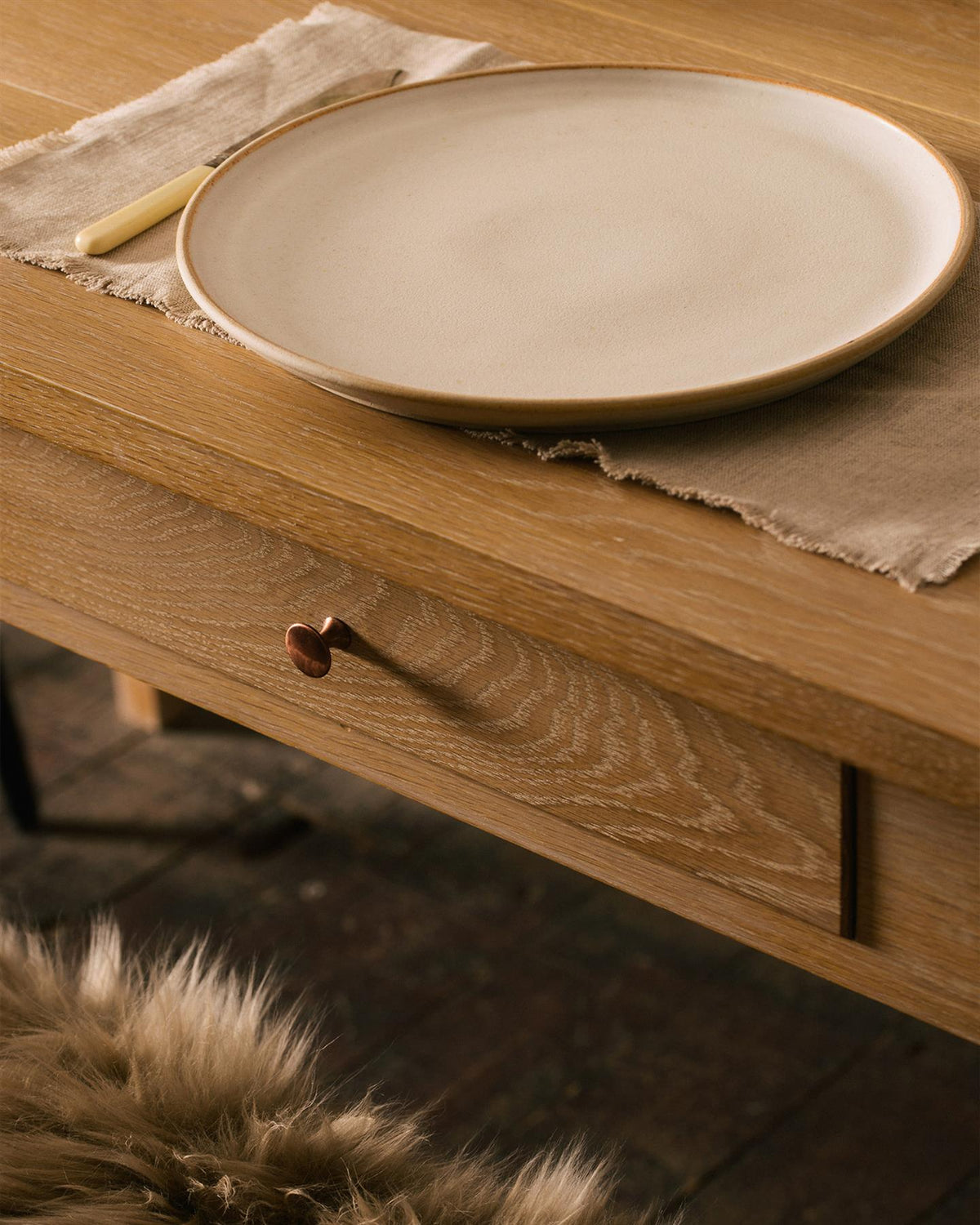 A close-up view of breadboard ends from an oak dining table. TEST
