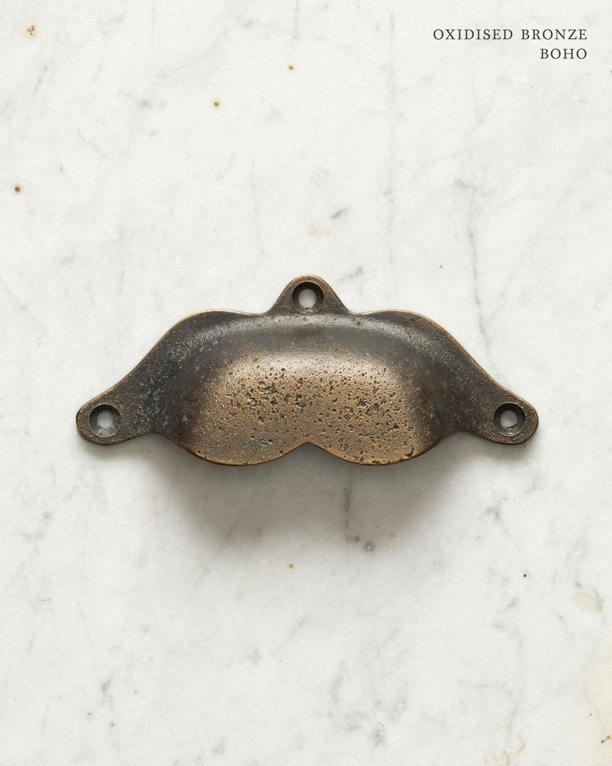 Two bohemian-style cup handles for a kitchen cupboard or drawer with a dark oxidised bronze finish. There is a large and a small size. TEST