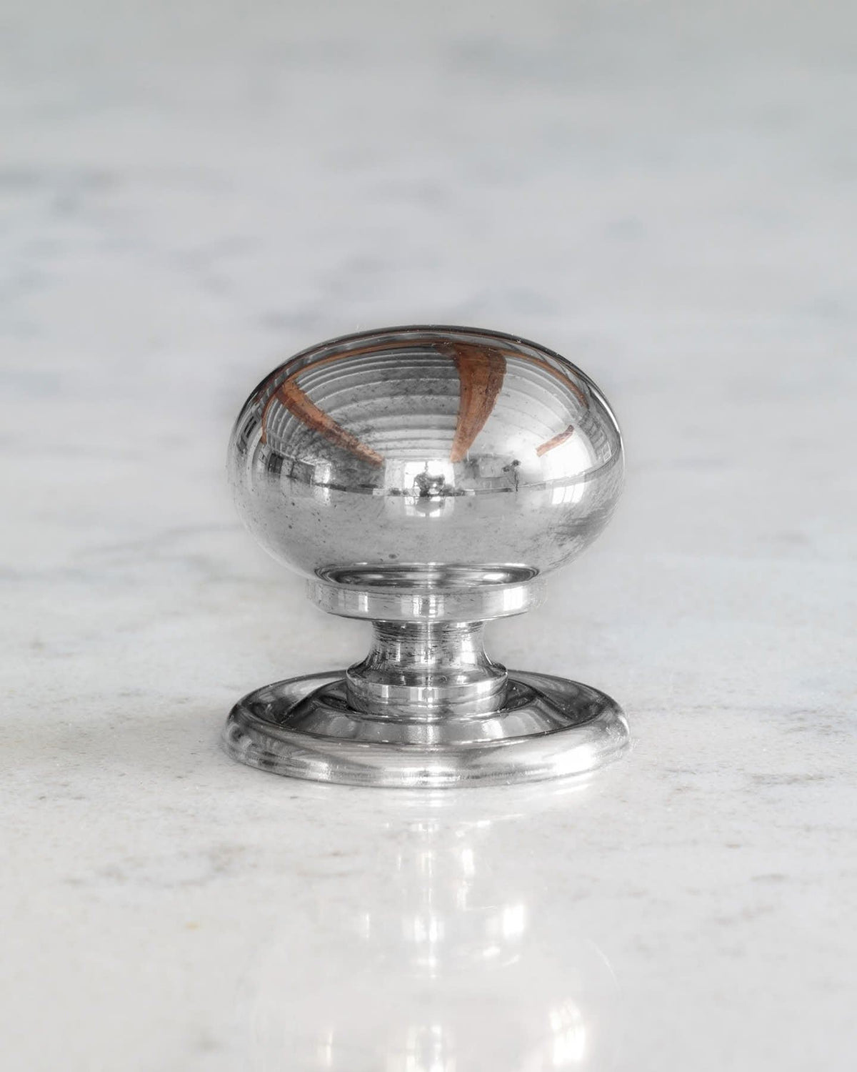A 'Medium' round doorknob with a pressed backplate for a kitchen cupboard or drawer in a polished chrome finish. TEST