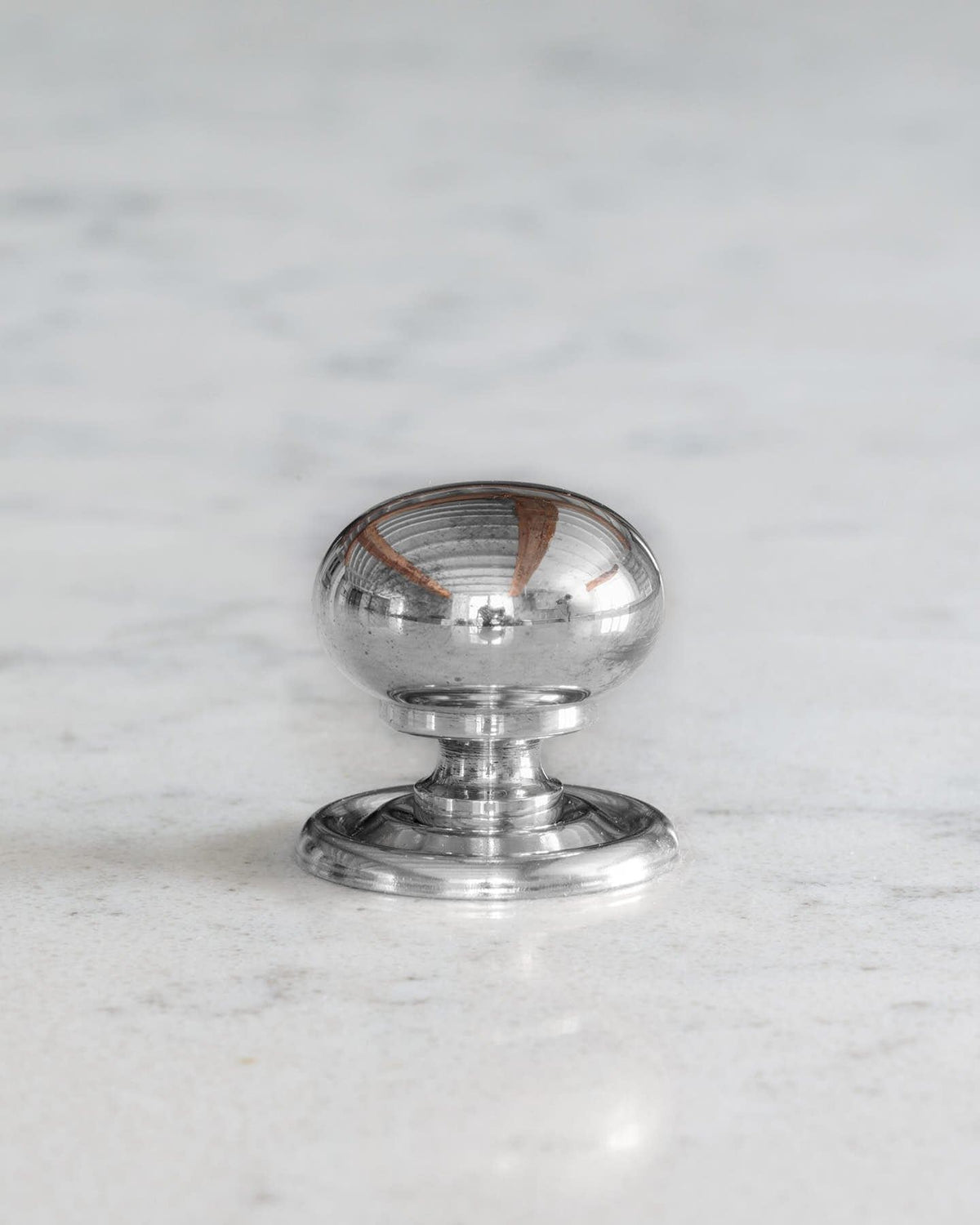 A 'Small' round doorknob with a pressed backplate for a kitchen cupboard or drawer in a polished chrome finish. TEST