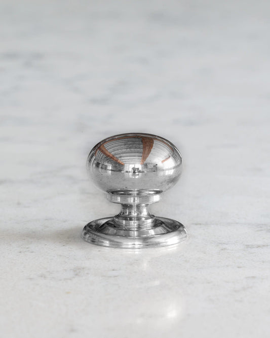 A 'Small' round doorknob with a pressed backplate for a kitchen cupboard or drawer in a polished chrome finish.