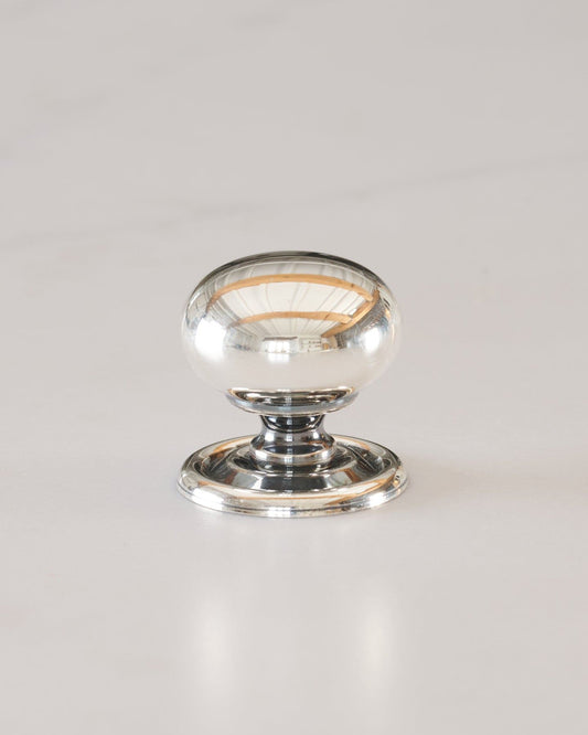 A 'Medium' round doorknob with a pressed backplate for a kitchen cupboard or drawer in a tarnished silver finish.