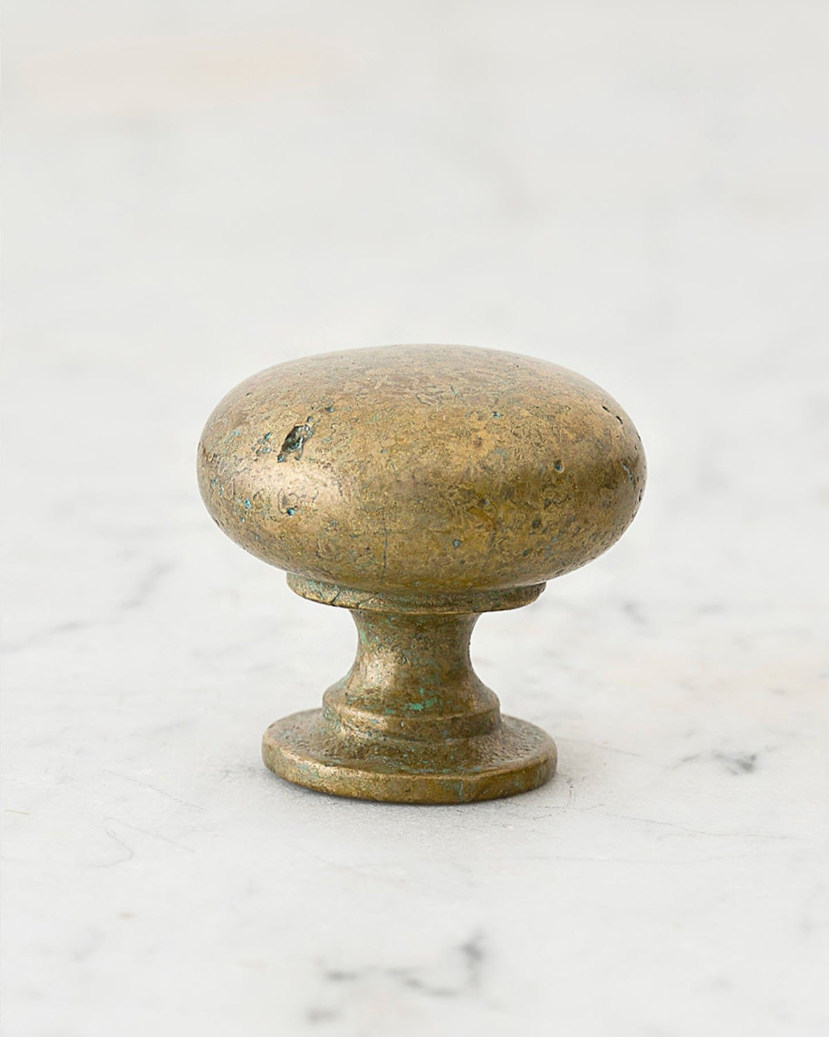 A 'Large' classic knob for a kitchen cupboard or drawer with an aged verdigris brass finish and unique dented textures as if was made by an artisan blacksmith centuries ago. TEST