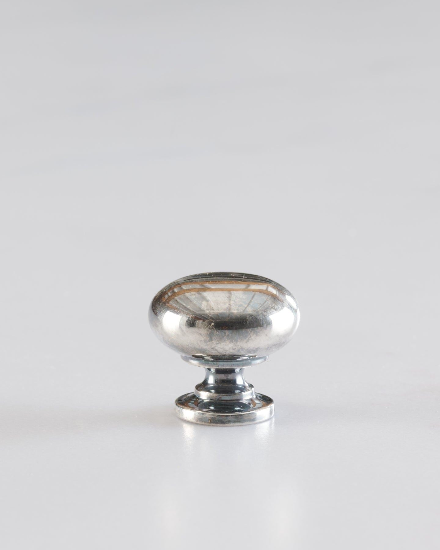 A 'Small' classic knob for a kitchen cupboard or drawer with a tarnished silver finish.