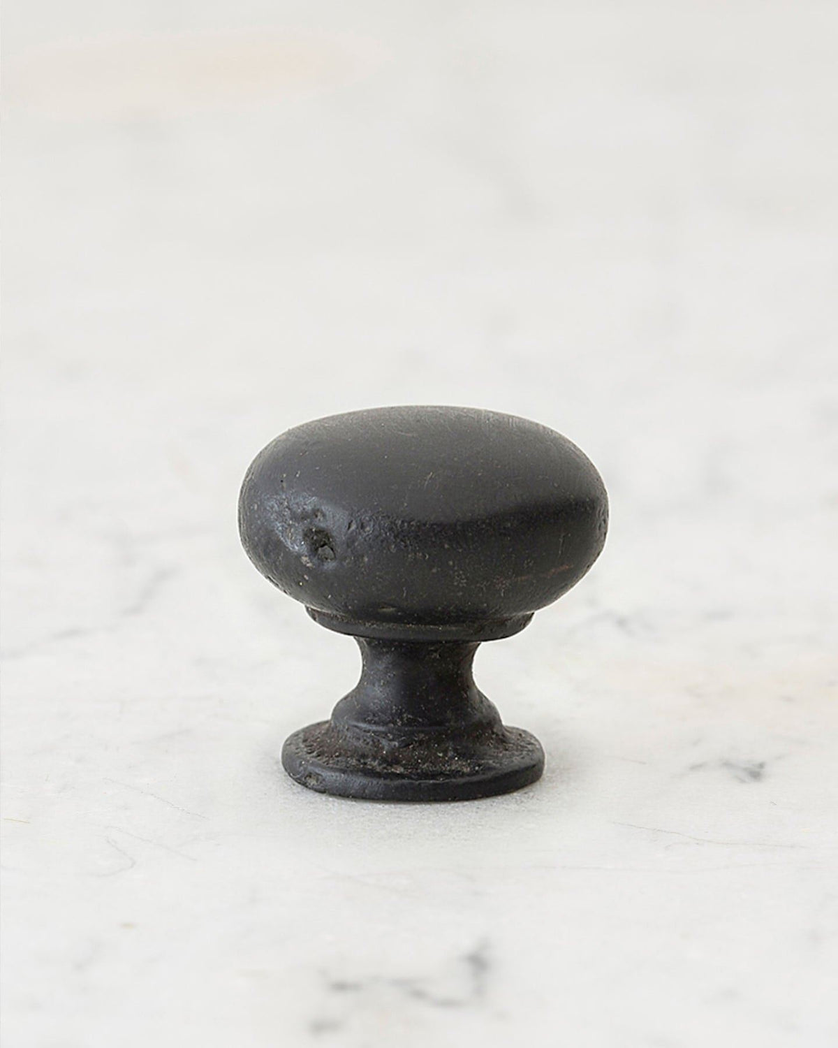 A 'Medium' classic knob for a kitchen cupboard or drawer with a matt black bronze finish that makes it look like a beloved, well aged brass from centuries ago. TEST