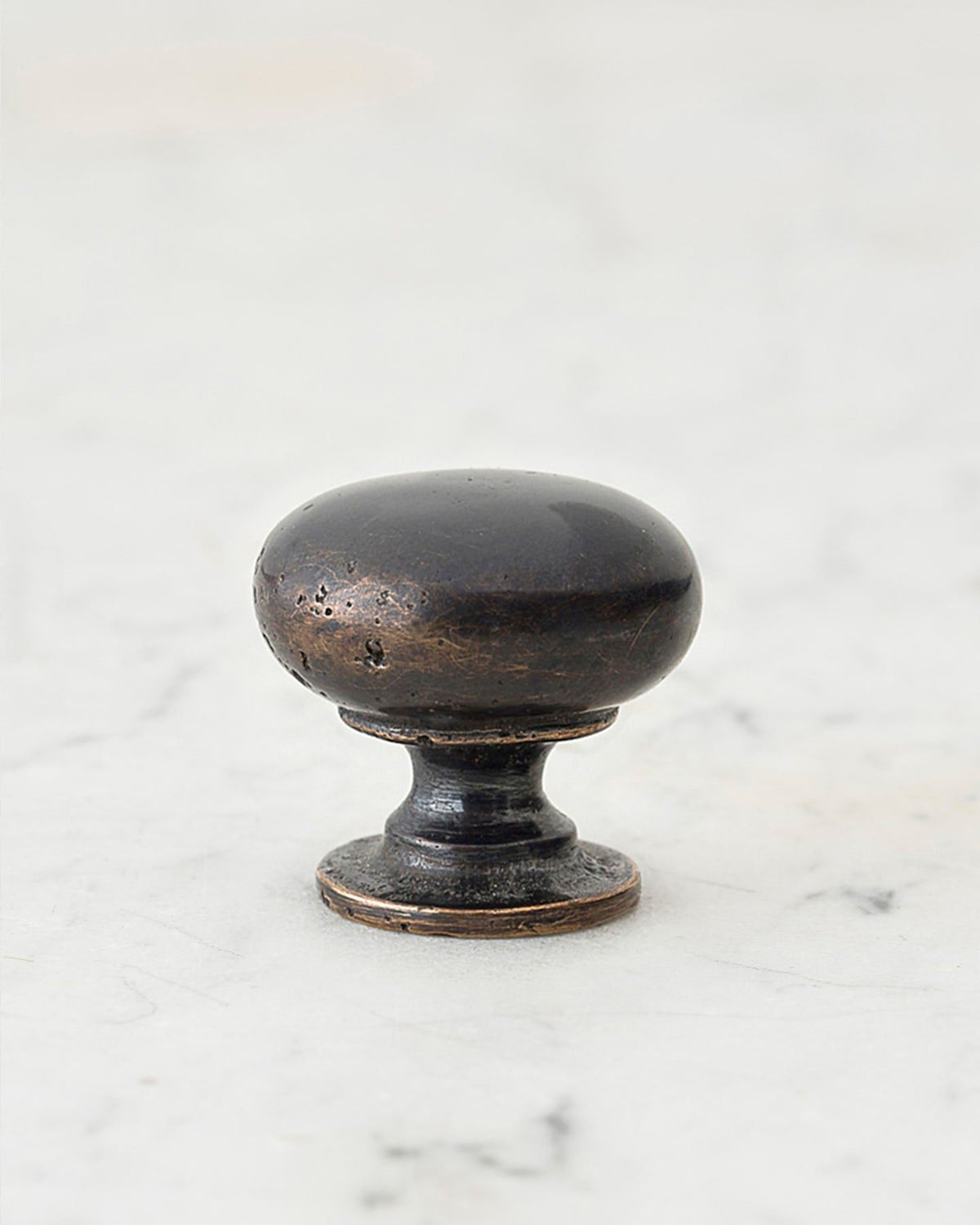 A 'Medium' classic knob for a kitchen cupboard or drawer with a dark oxidised bronze finish and unique dented textures as if was made by an artisan blacksmith centuries ago. TEST