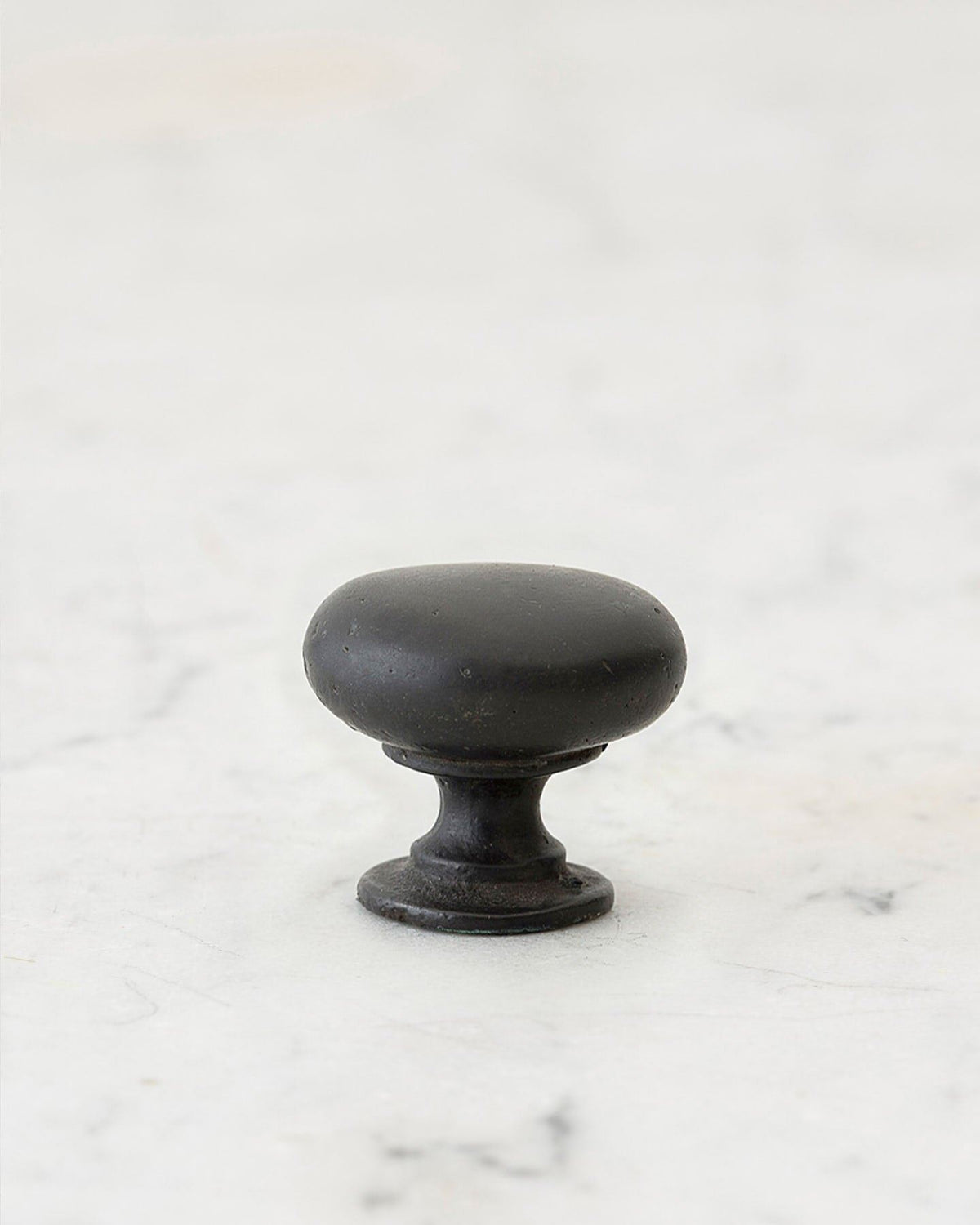 A 'Small' classic knob for a kitchen cupboard or drawer with a matt black bronze finish that makes it look like a beloved, well aged brass from centuries ago. TEST