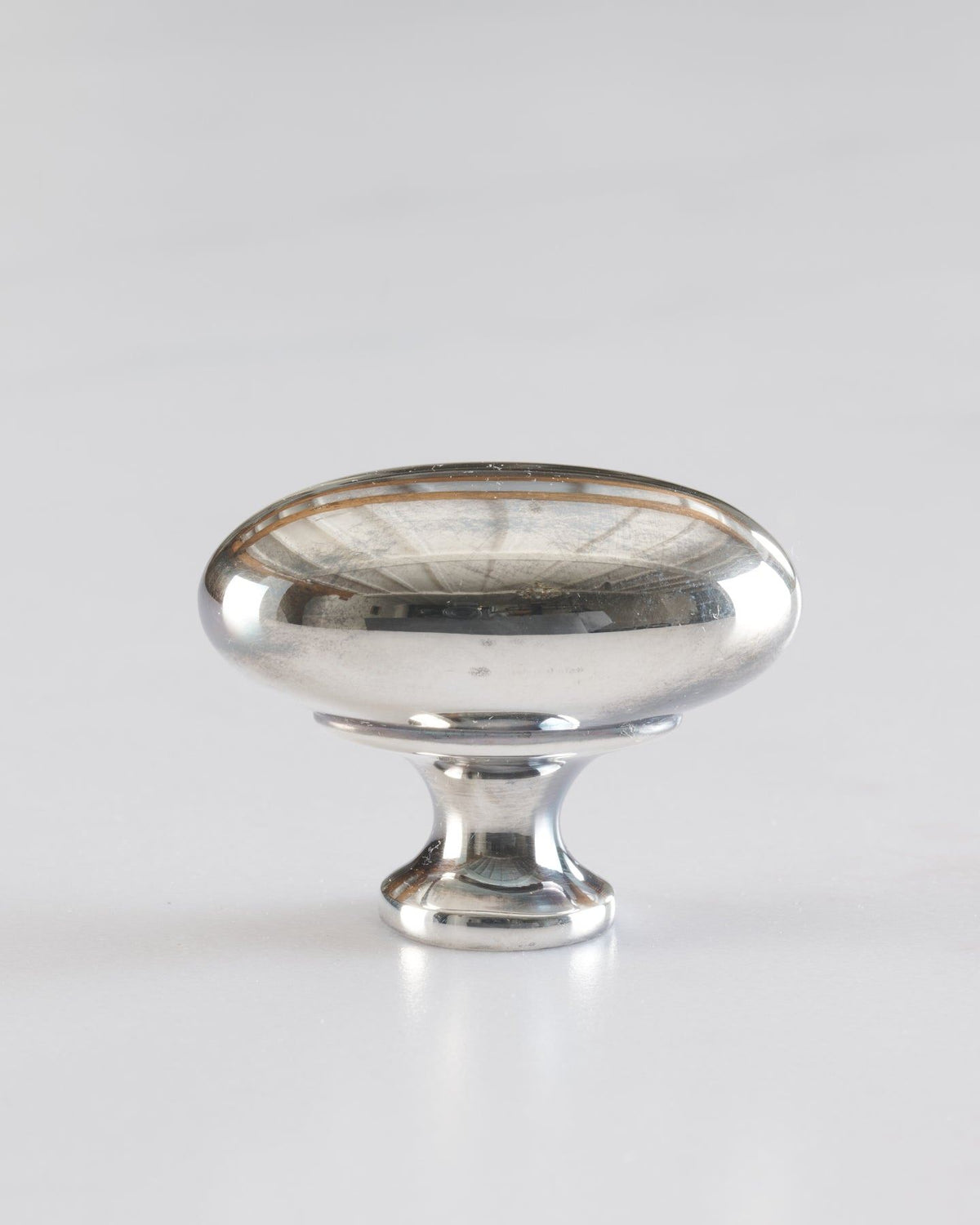 A 'Large' oval-shaped knob for a kitchen cupboard or drawer with a tarnished silver finish. TEST