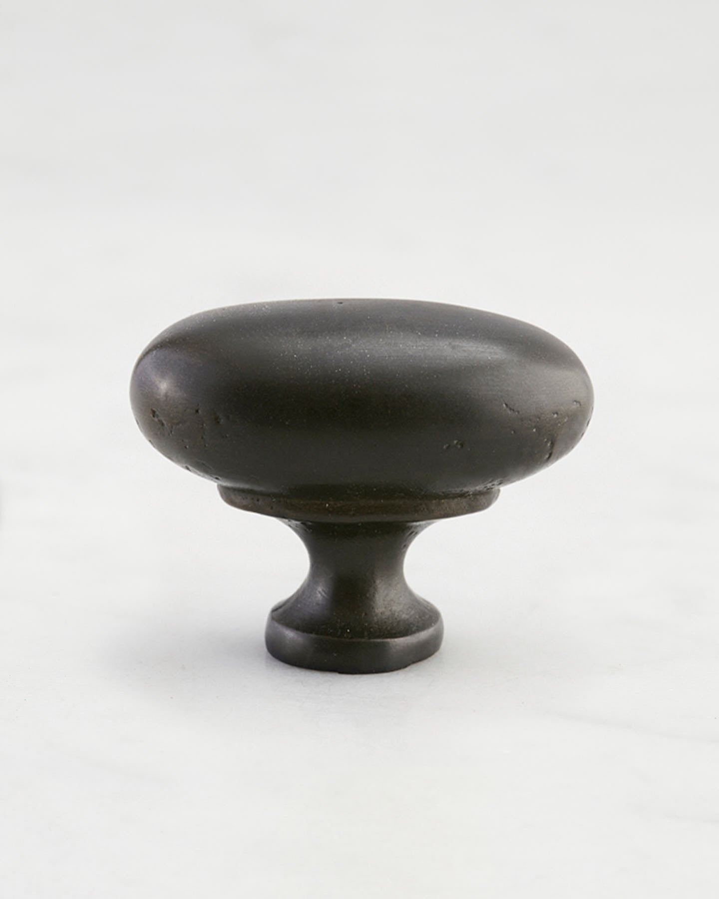 A 'Large' oval-shaped knob for a kitchen cupboard or drawer with a matt black bronze finish that makes it look like a beloved, well aged brass from centuries ago.