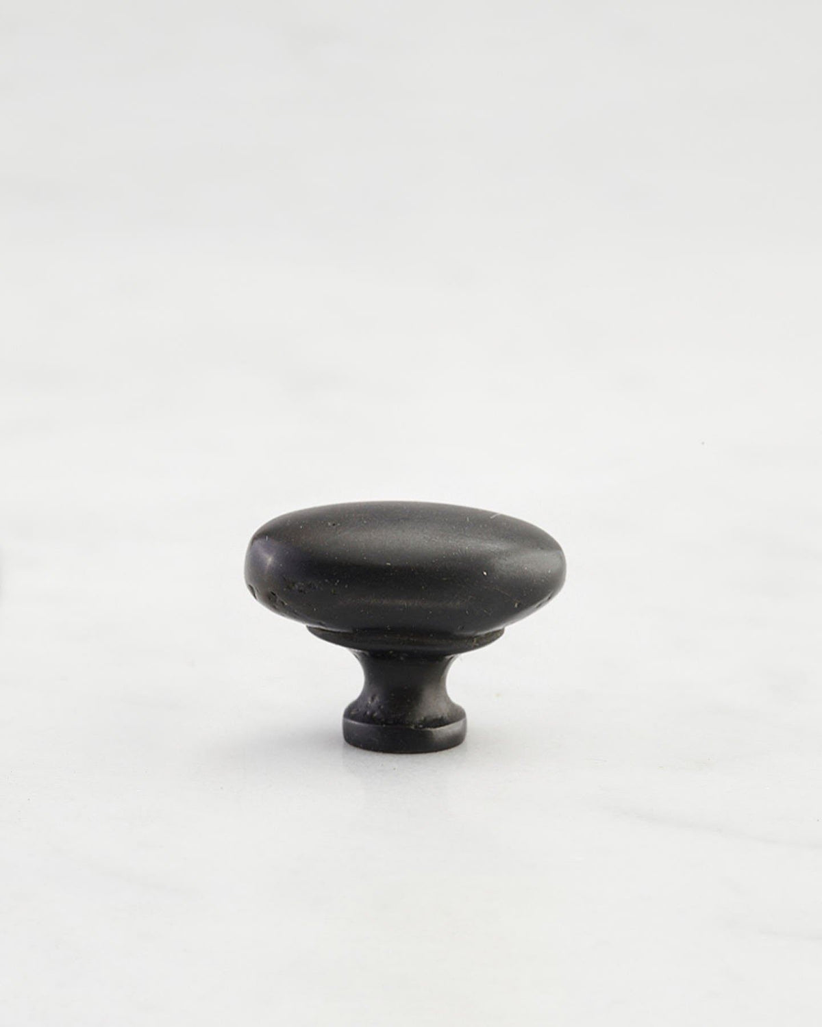 A 'Petite' oval-shaped knob for a kitchen cupboard or drawer with a matt black bronze finish. TEST