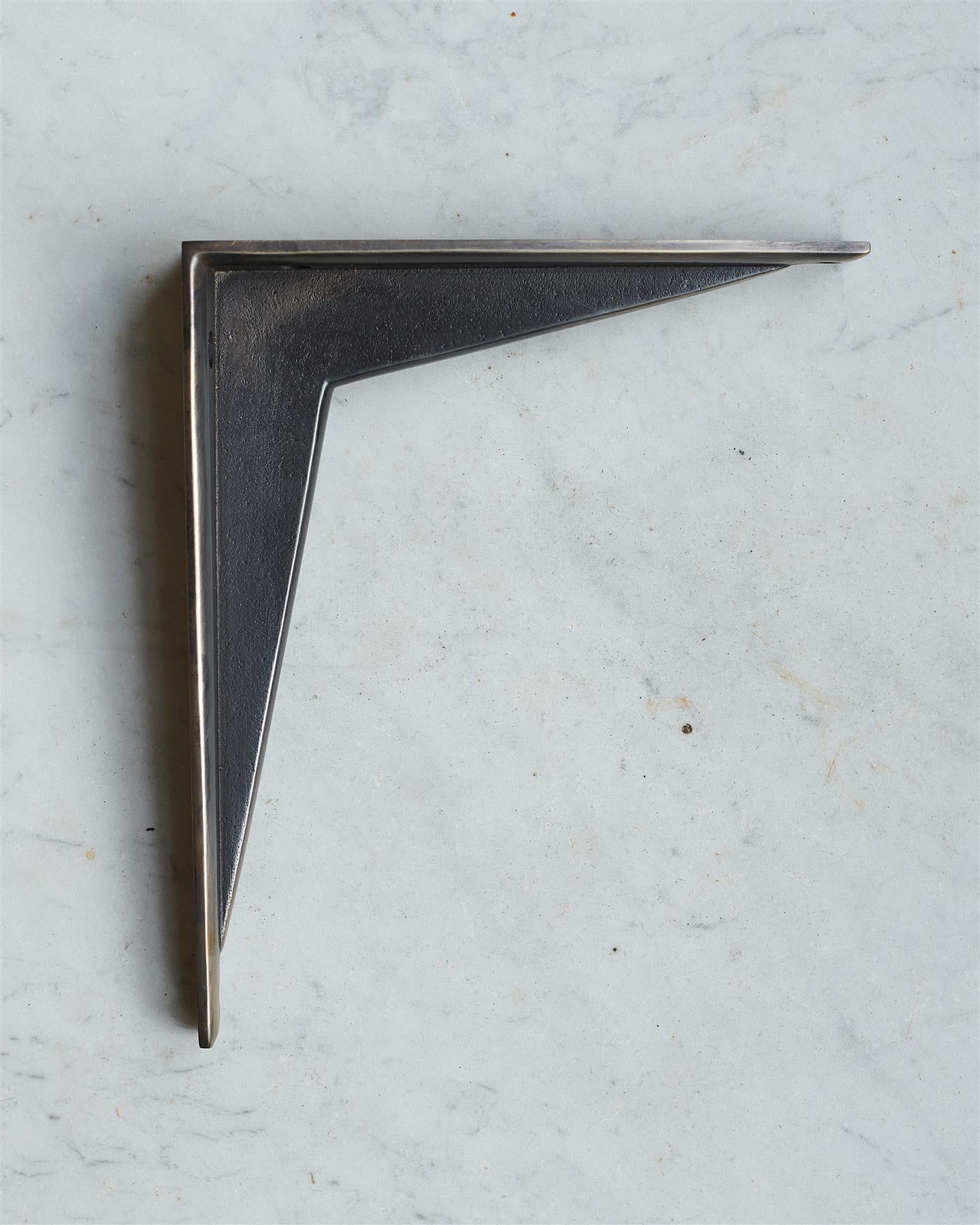 A side profile view of a classic utilitarian shelf bracket in a dark oxidised brass finish.