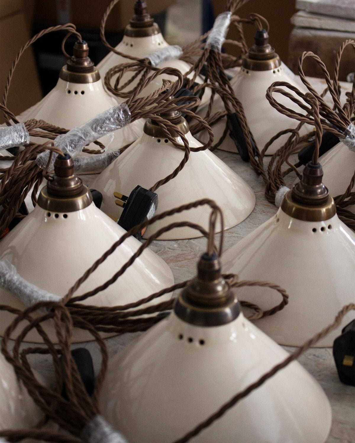 A collection of small plug-in lights with a cream glazed shades, brown twisted fabric flex cord and brass fittings. TEST