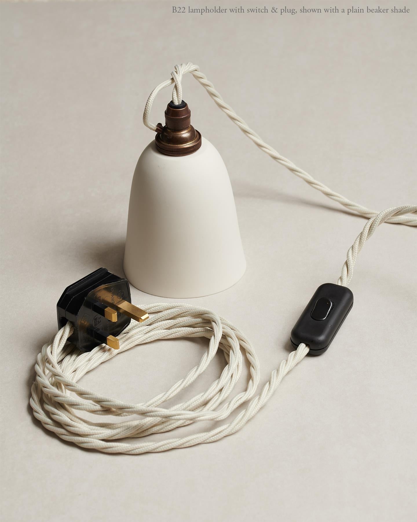 An oblique view of a small pleated porcelain light hanging over a Carrara marble sink.