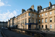The deVOL George Street, Bath showroom is a traditional tall, three floor, bath stone building with the iconic deVOL blue on the rim of the pillars of the front door, signs and a golden deVOL logo.