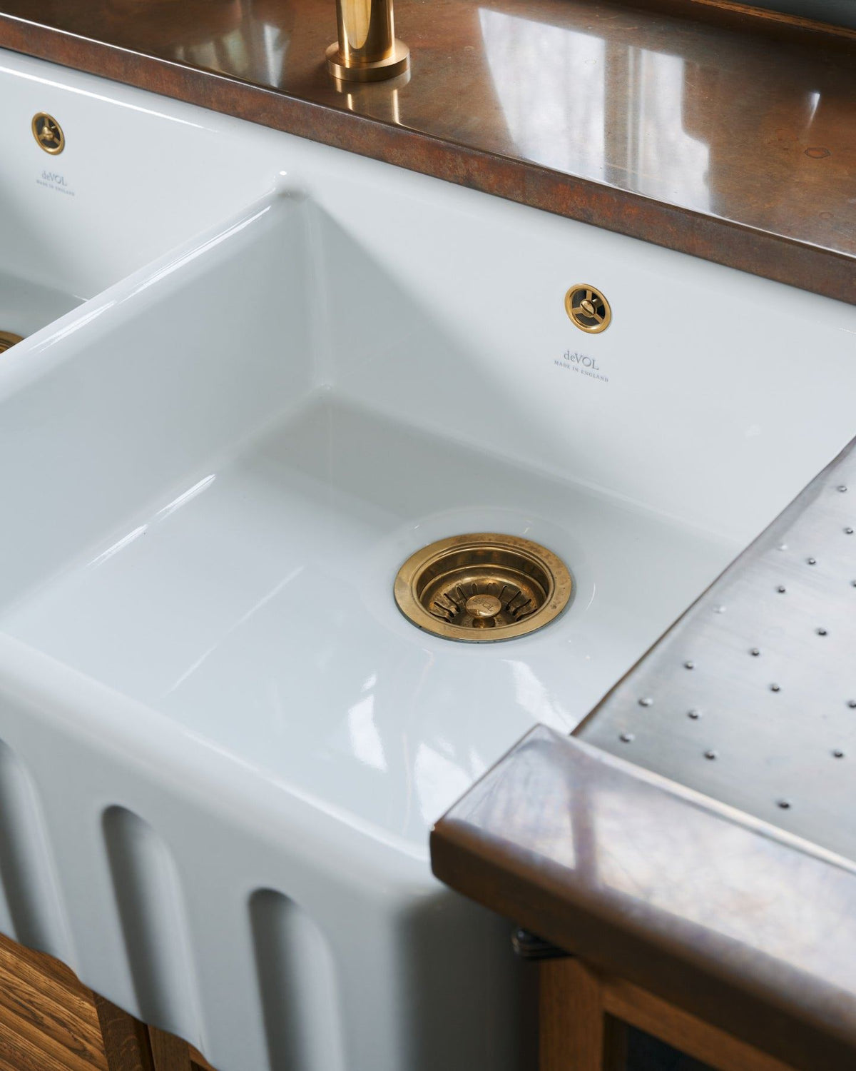 A close-up oblique view of the right-hand bowl of an extra large ceramic Belfast sink. TEST