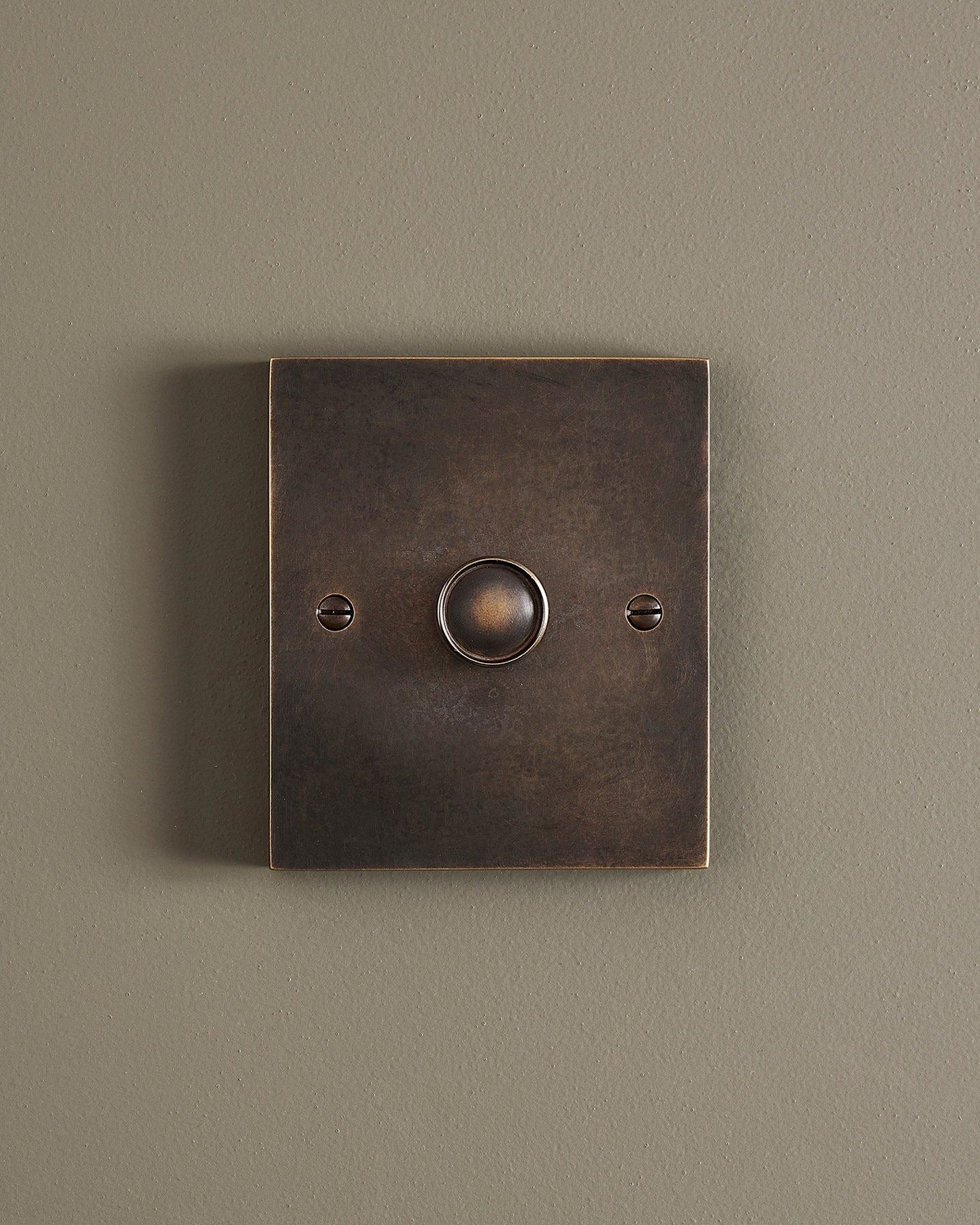 A straight-on view of a 1 gang box dimmer switch in a dark oxidised brass finish.